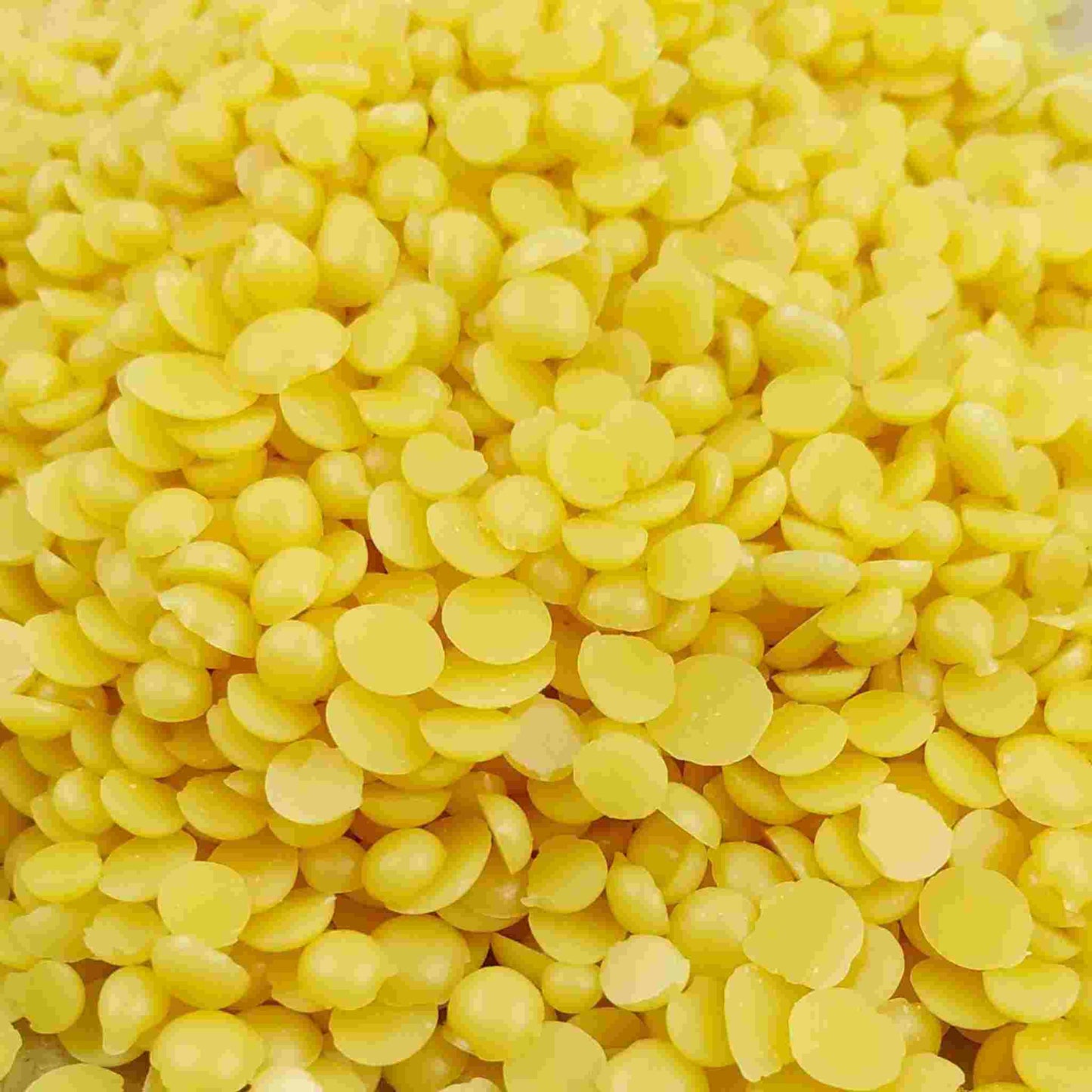 Pure Candelilla Wax flakes displayed, highlighting their use as a vegan, sustainable alternative for cosmetics, candles, soaps, and natural furniture polish, perfect for eco-conscious crafting.