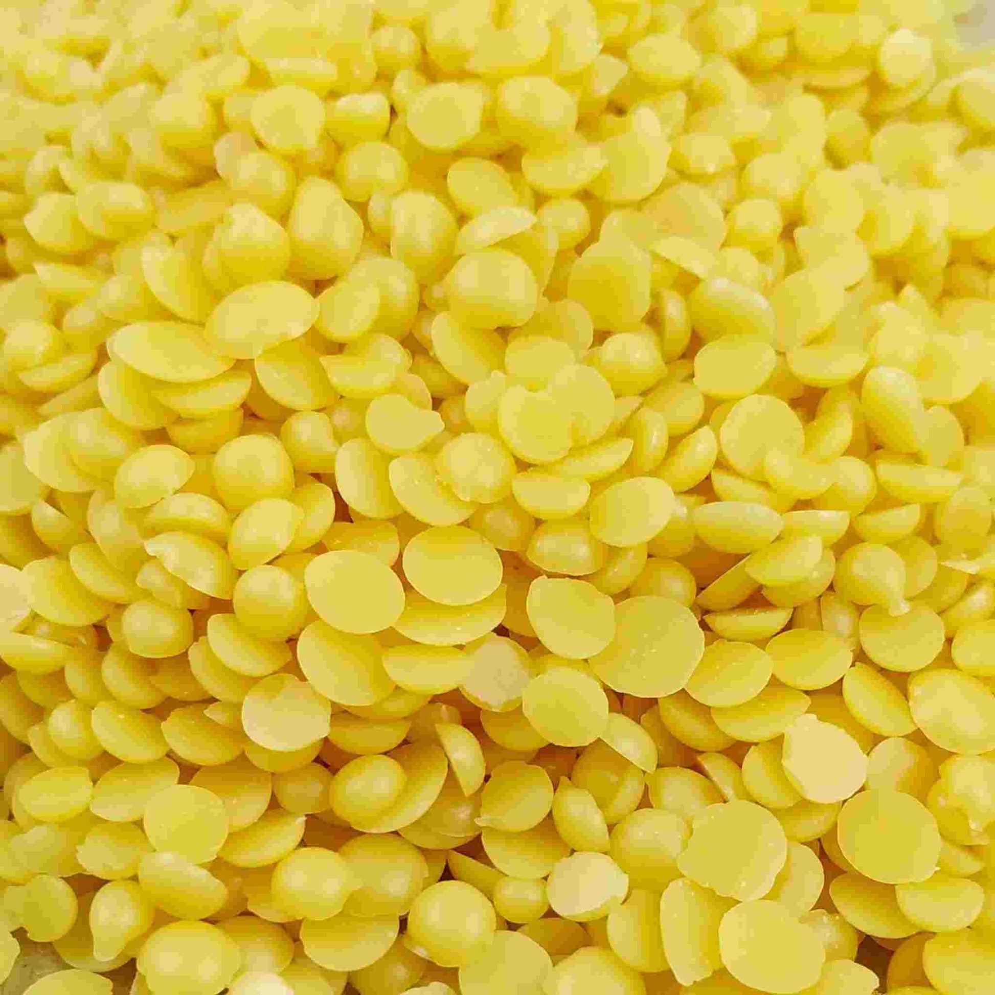 Pure Candelilla Wax flakes displayed, highlighting their use as a vegan, sustainable alternative for cosmetics, candles, soaps, and natural furniture polish, perfect for eco-conscious crafting.