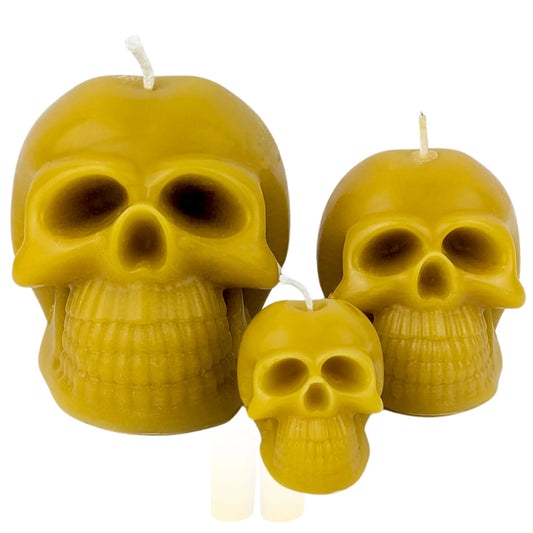 Skull-shaped beeswax candle trio for Halloween décor.