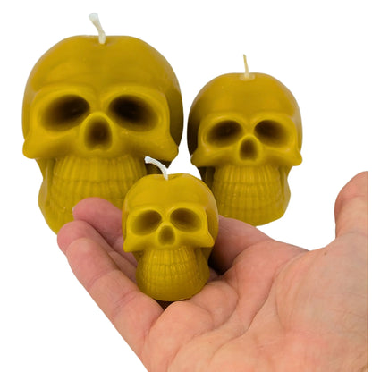 Gothic-style beeswax skull candles for spooky ambiance.