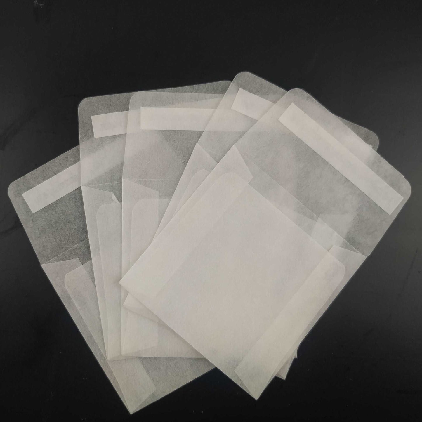 Variety of biodegradable glassine envelopes with peel and seal closure, ideal for wedding confetti, wax melts, and eco-conscious packaging needs
