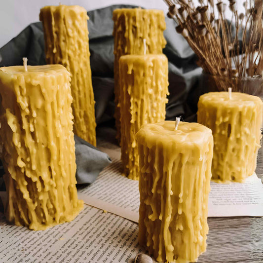 Handcrafted pure beeswax candle with a natural drip texture, illuminated, showcasing its unique rustic charm