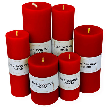 Shop vibrant red pillar candles for cozy home decor warmth, displayed in a living room.