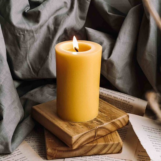Handmade pure beeswax pillar candle, smooth and round, showcasing natural elegance and emitting a warm, eco-friendly glow, crafted with care in the UK.