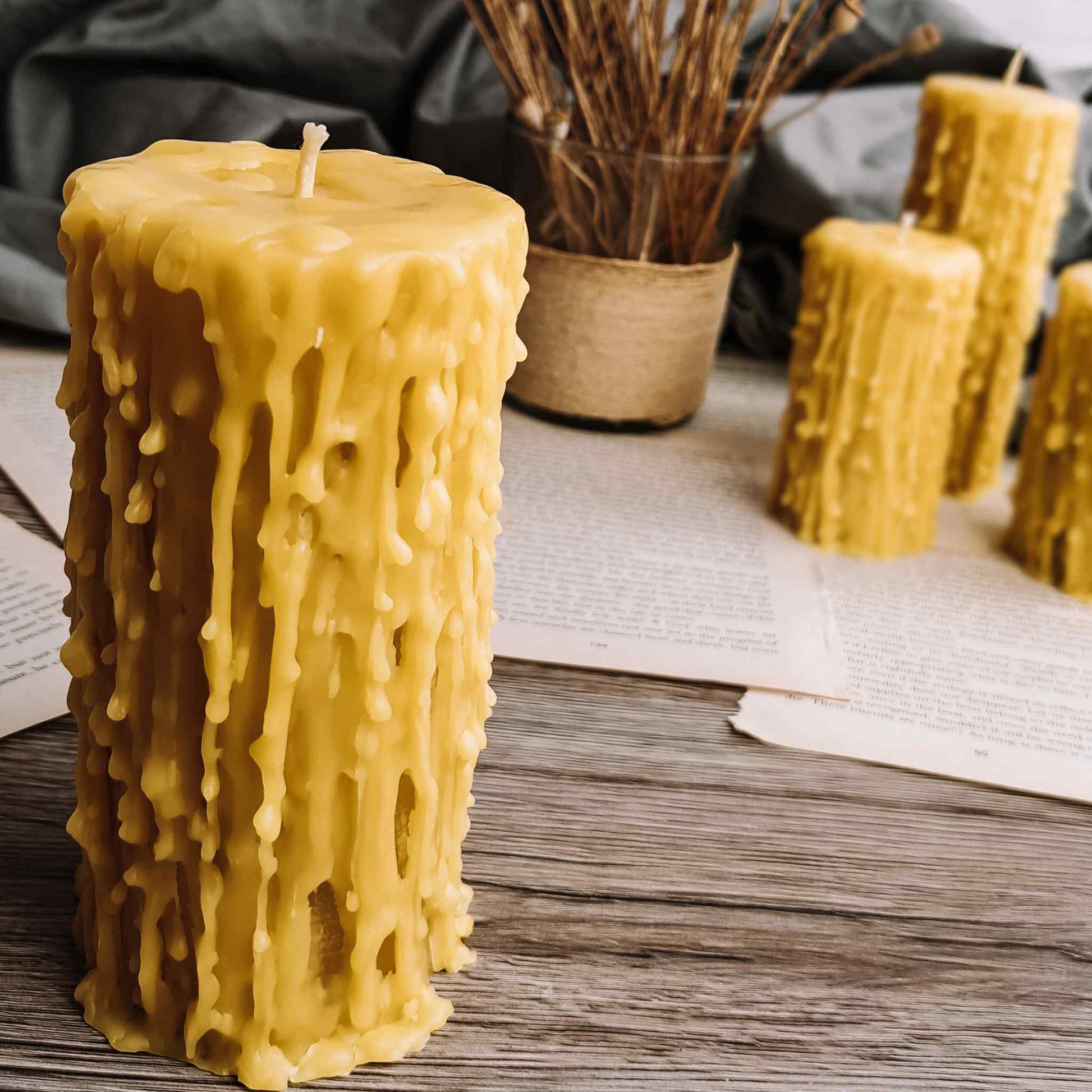 Variety of beeswax candles emitting a soft, warm glow, purifying the air in a serene home environment