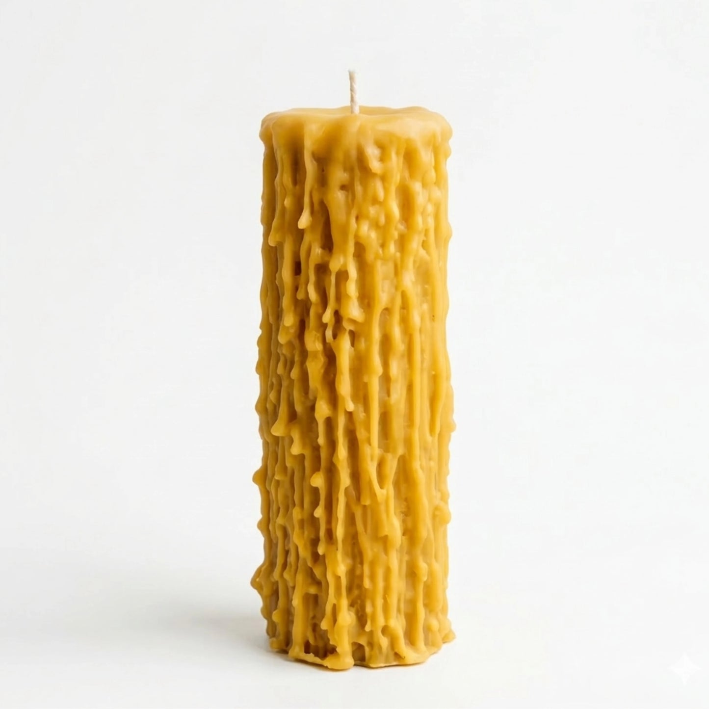 A well-organized, close-up photograph of five beeswax pillar candles arranged by increasing height on a light-colored surface. The two shortest candles are in sharp focus, showcasing their unique dripped, highly textured natural yellow wax.
