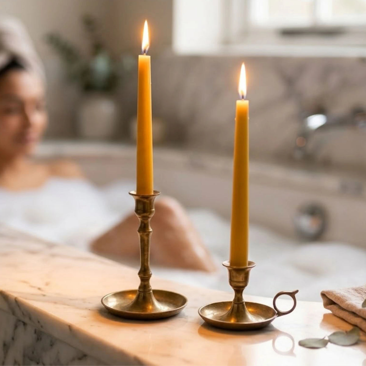 Close-up of eco-friendly British beeswax taper candles featuring unbleached natural cotton wicks.