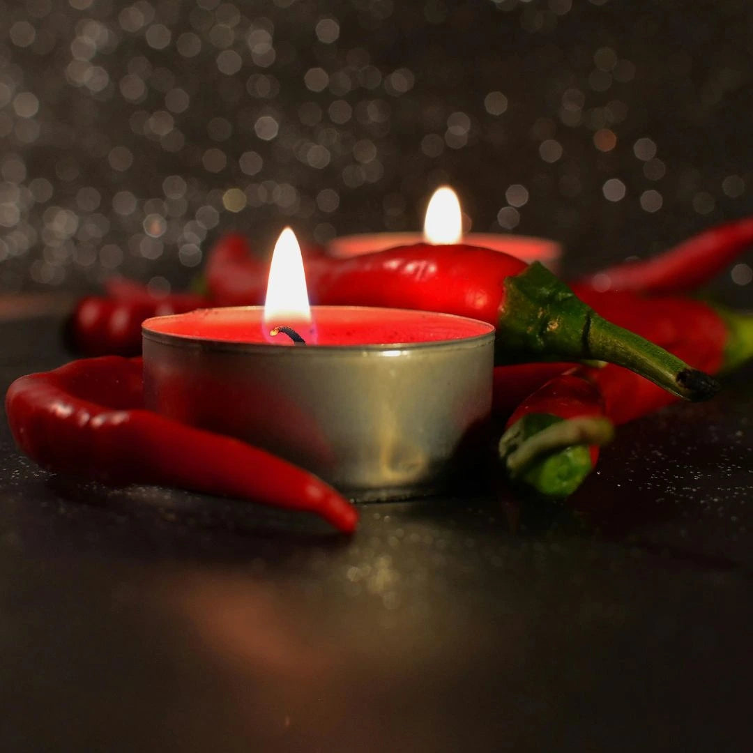 Close-up of vibrant red beeswax tealights arranged in heart-shaped patterns, perfect for Valentine's Day celebrations and romantic home décor.